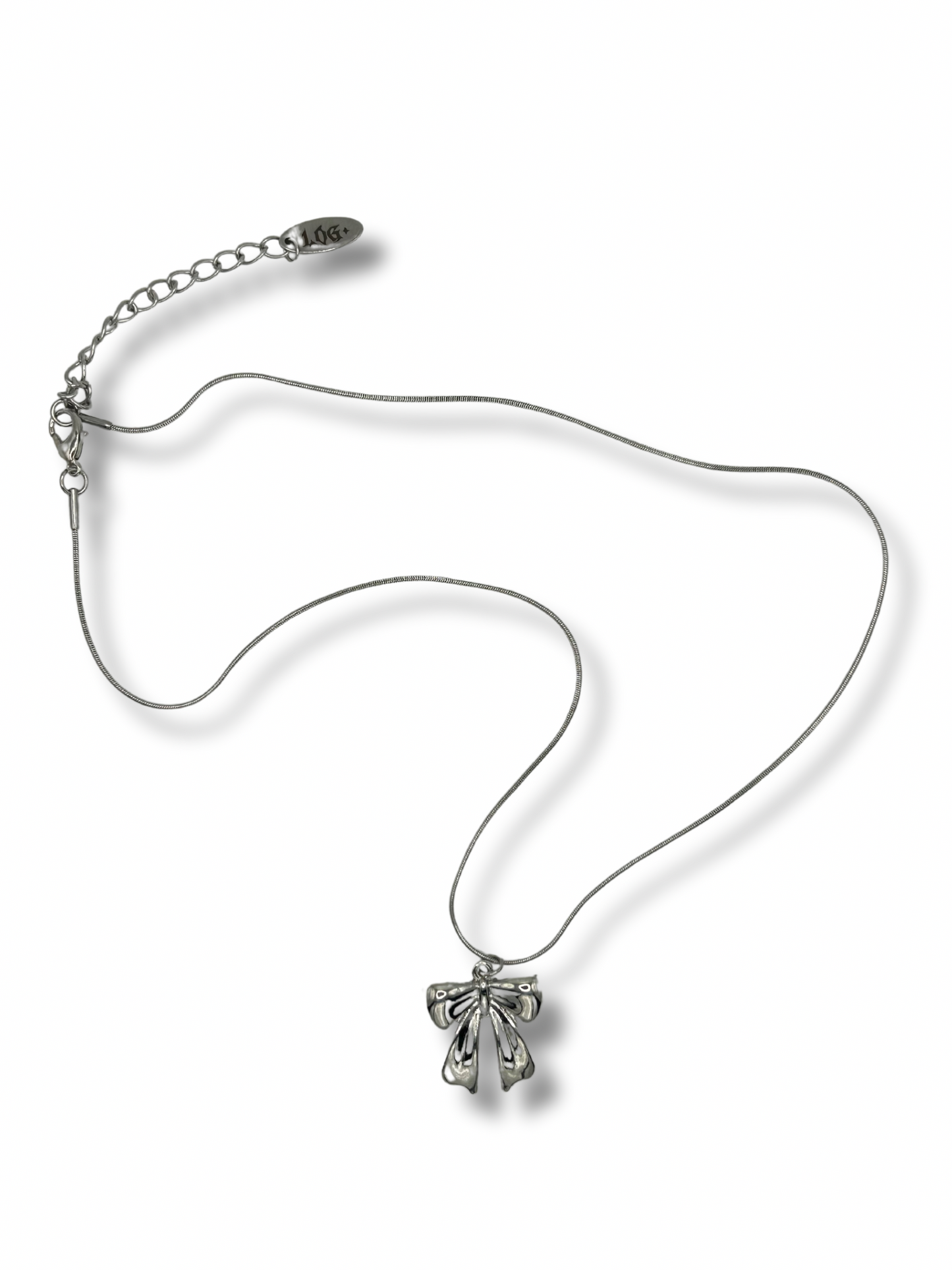 A small silver bow pendant hanging off a silver chain necklace