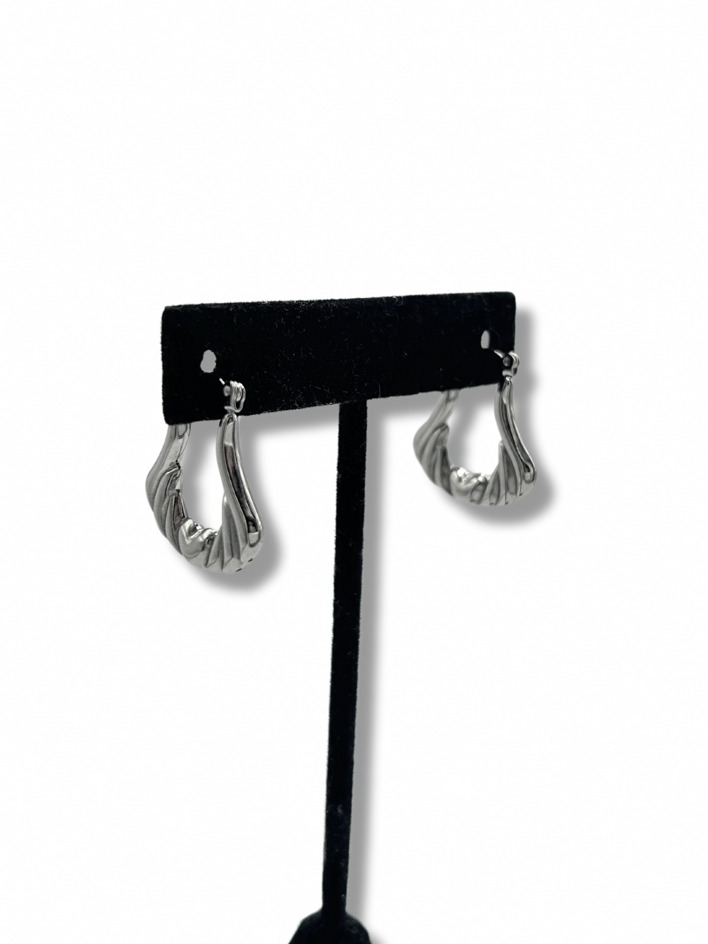 silver stainless steel angel wing hoop earrings on a black jewellery stand