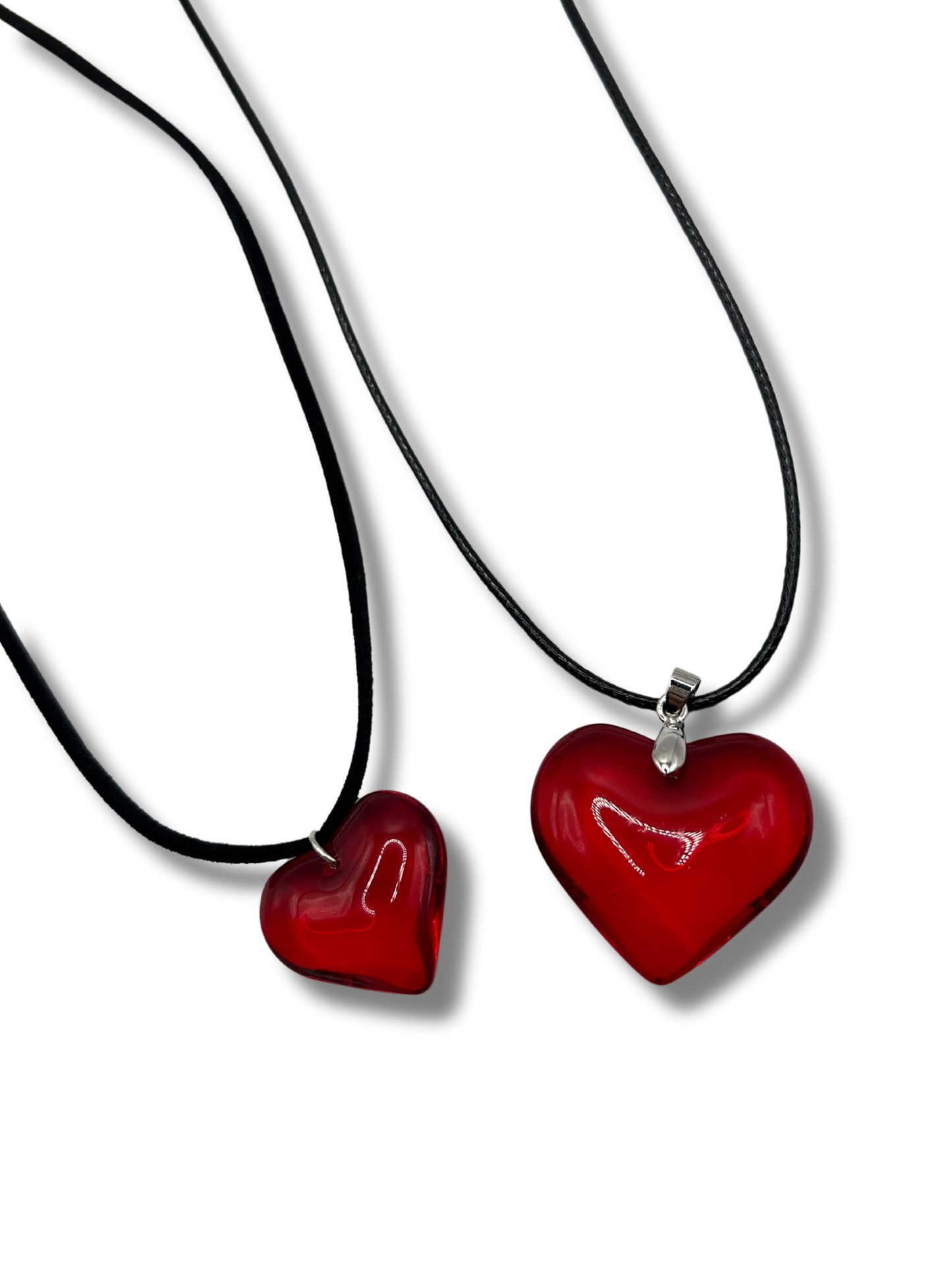 2 love heart pendants on a black leather cord