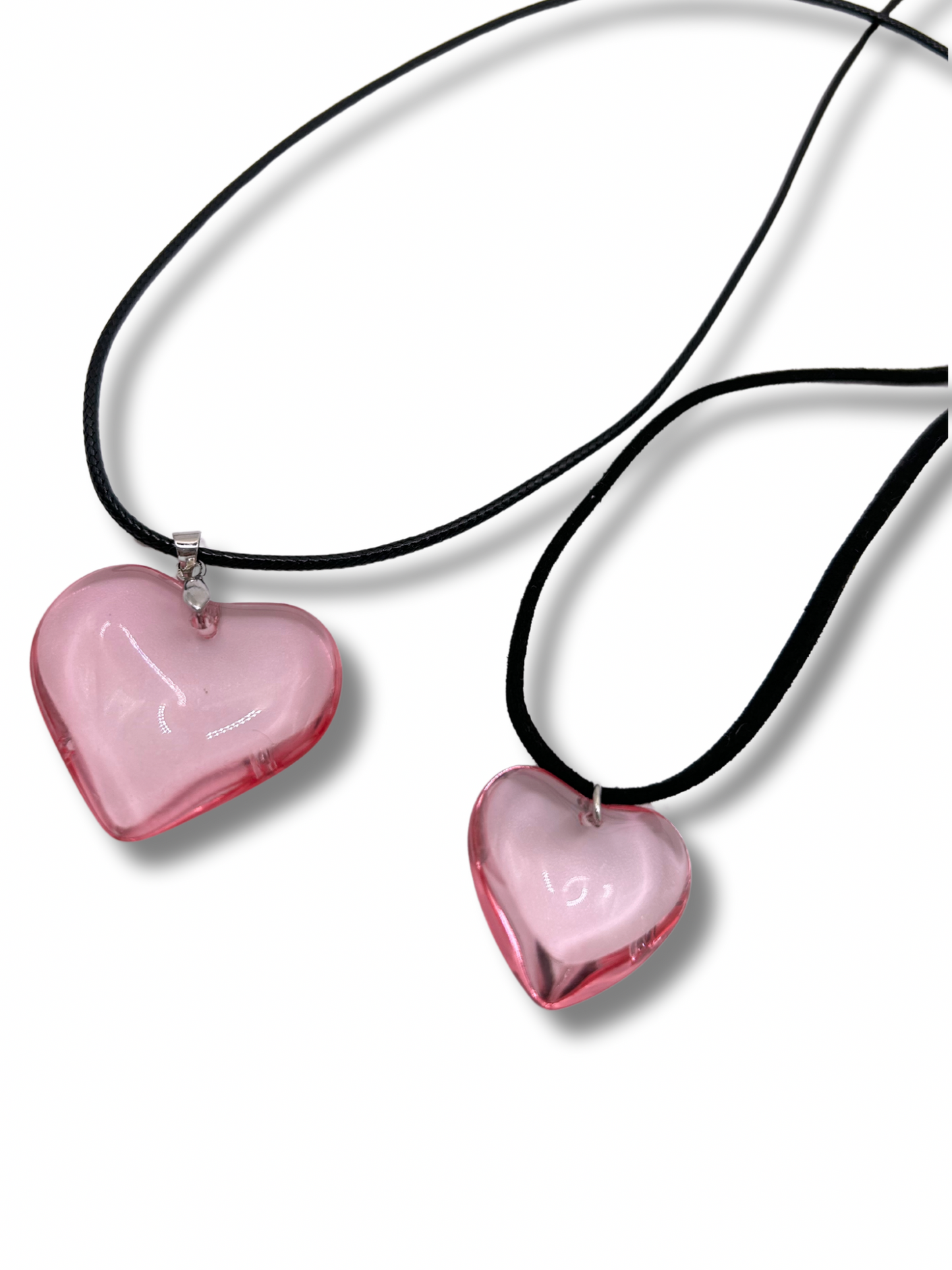 2 pink glass style pendants on a leather cord necklace