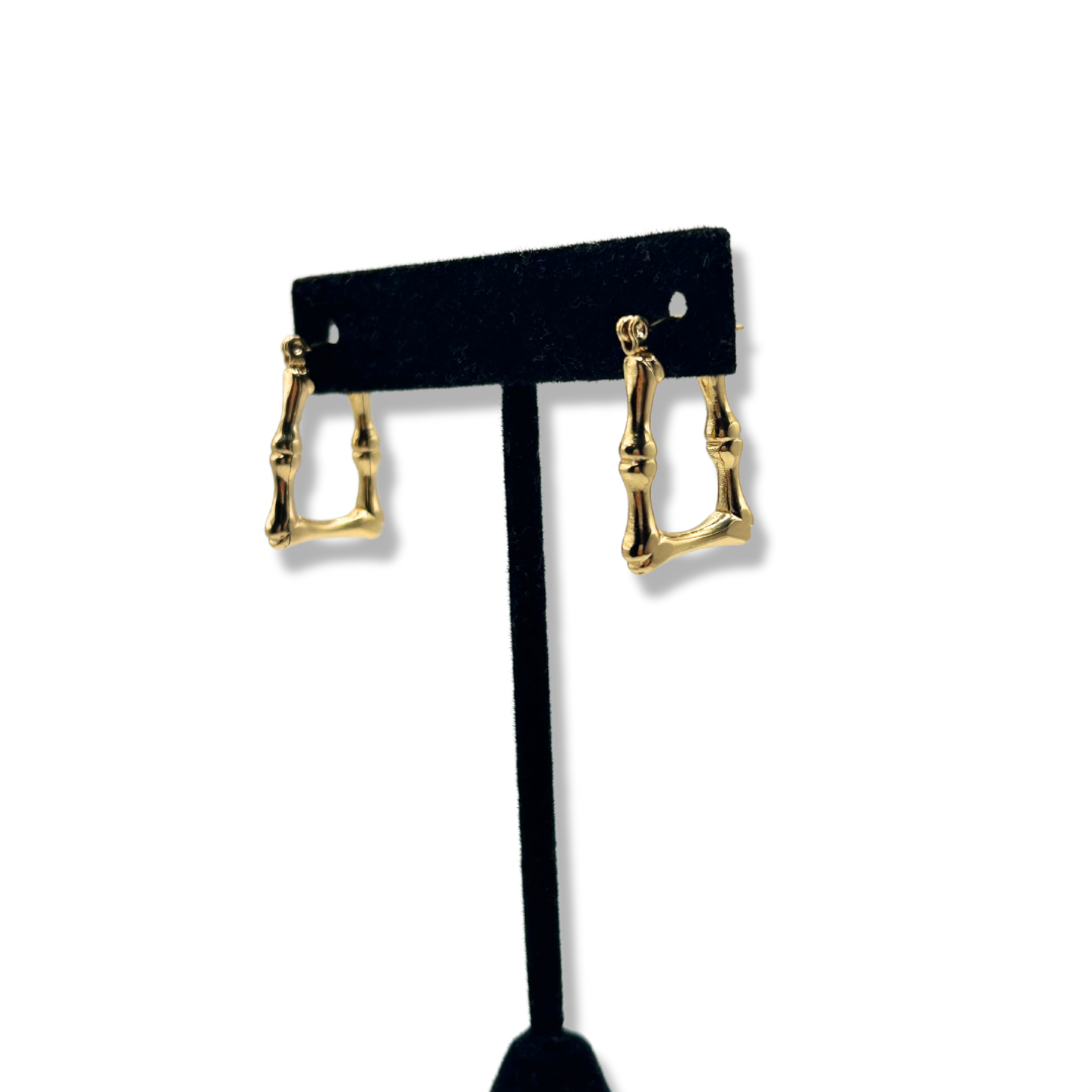 gold bamboo square hoop earrings on a black earring stand
