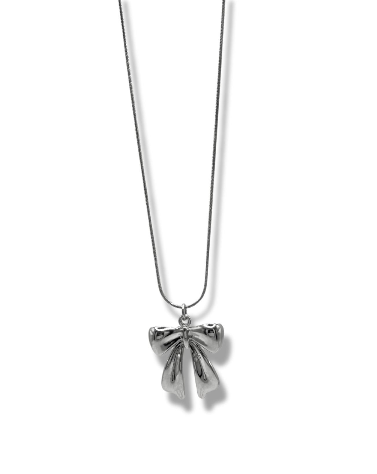 a dainty bow pendant on a snake chain necklace