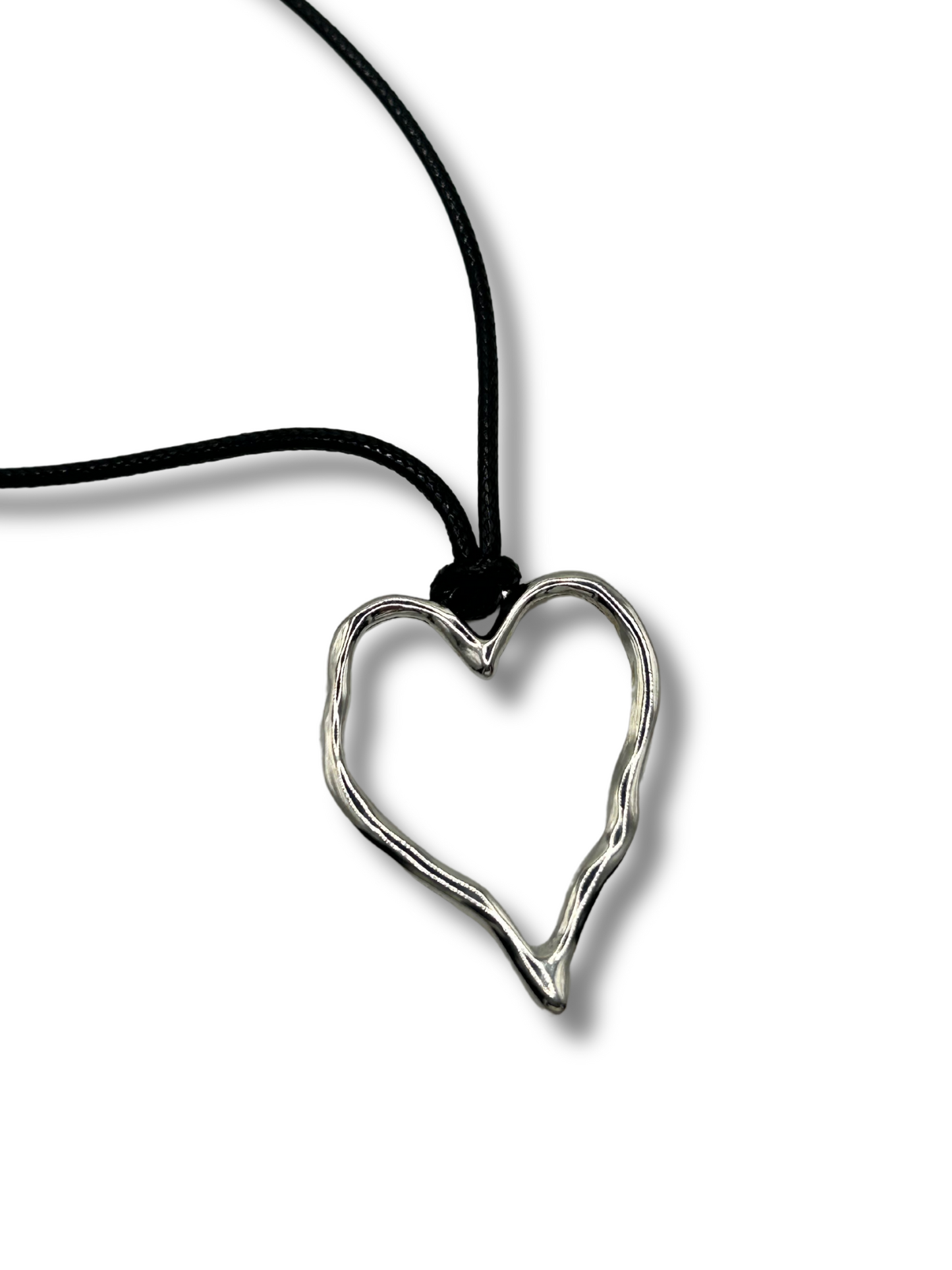 a black leather cord chain with a stainless steel silver hammered heart pendant. it's shiny