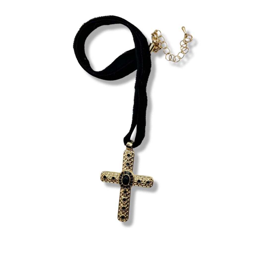 a black velvet choker with a gold cross pendant adorned with black gems