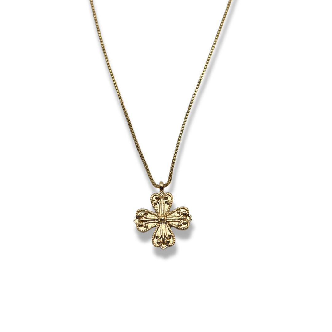 an ornate cross/clover gold pendant necklace