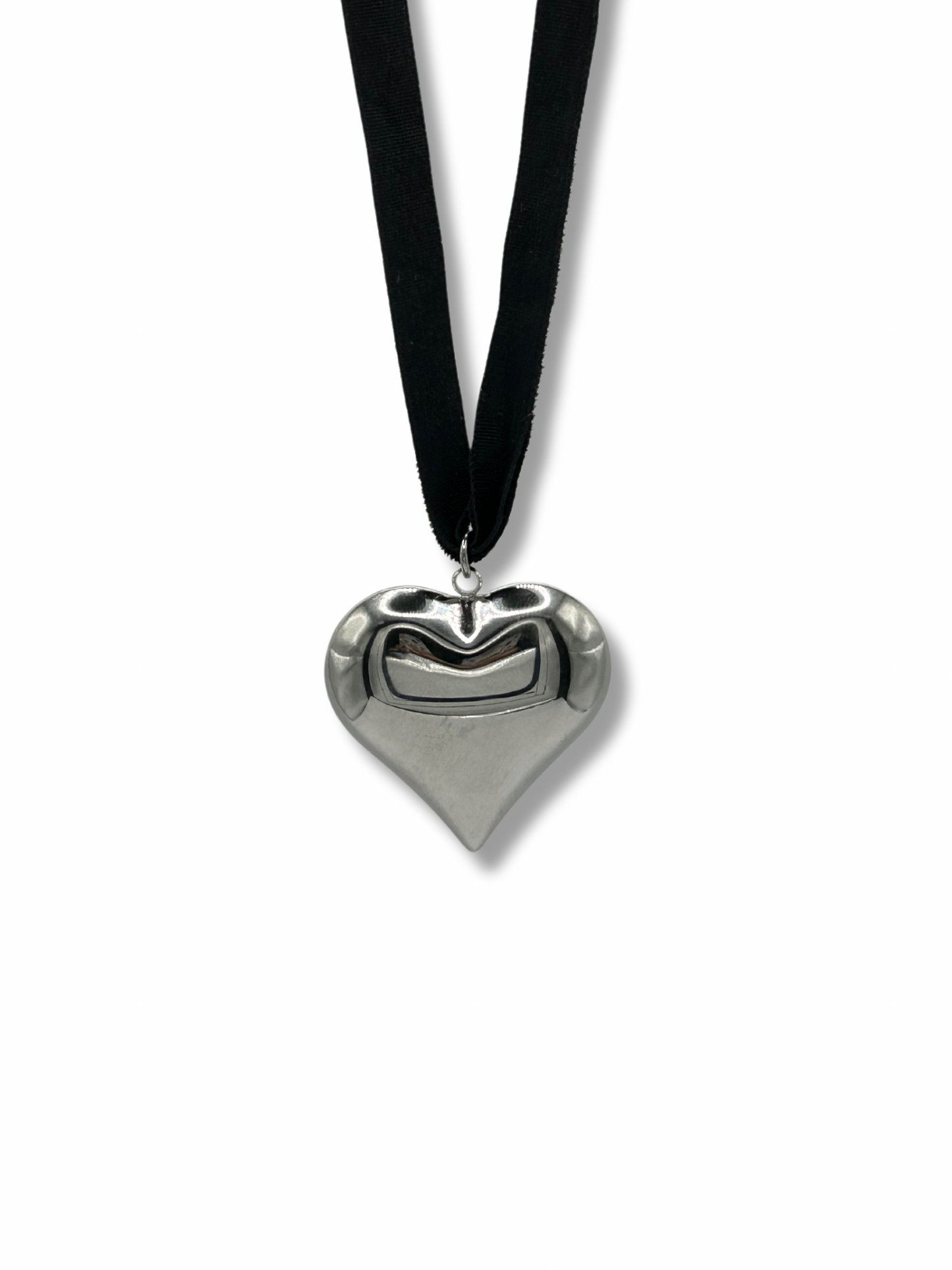 Silver heart pendant hanging on a black ribbon necklace