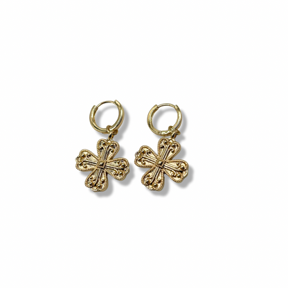dangly cross/clover gold earrings on a white background