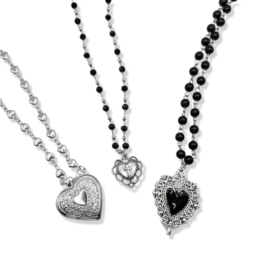 3 vintage heart necklaces together on a white background