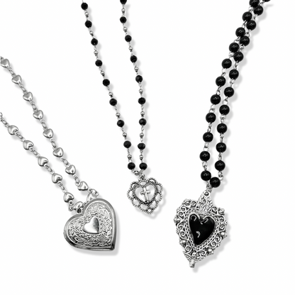 3 vintage heart necklaces together on a white background