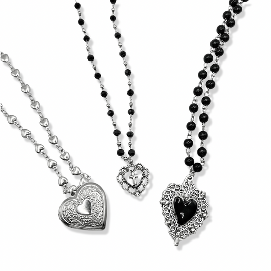3 vintage heart necklaces together on a white background