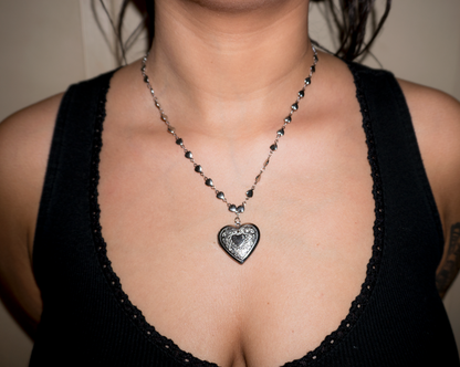 girl wearing a heart locket rosary necklace